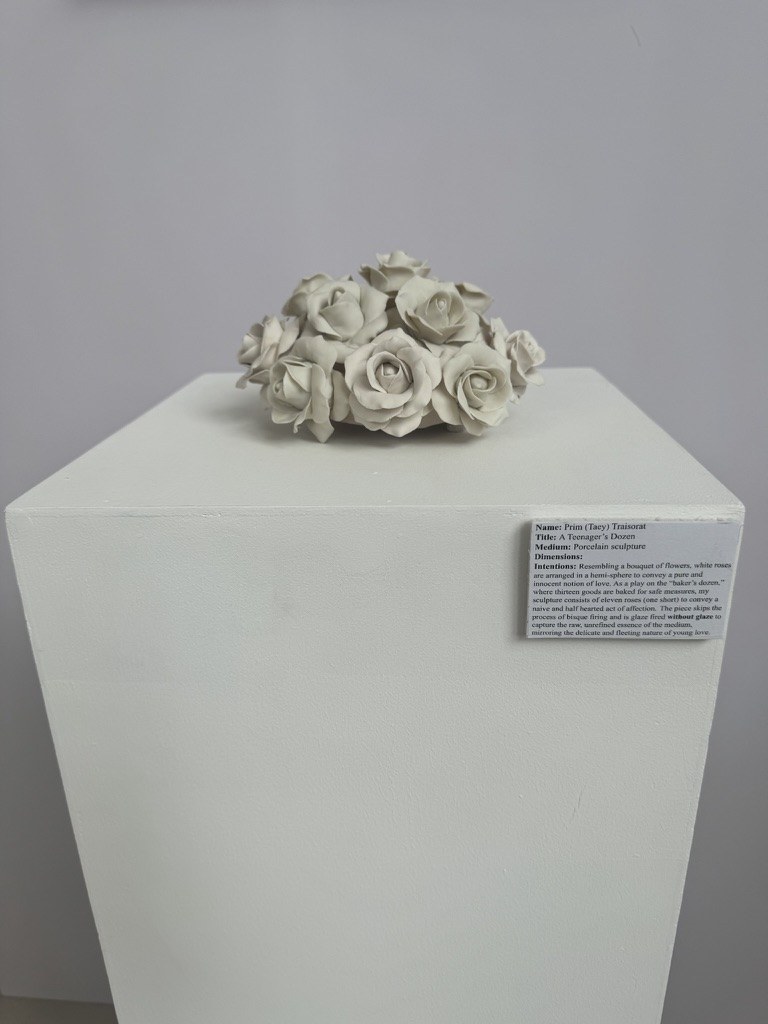 A Teenager’s Dozen, an unglazed porcelain sculpture of eleven white roses on a plinth